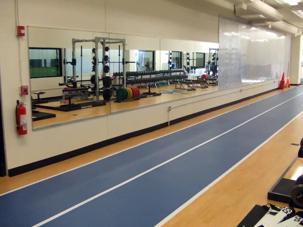 Synthetic flooring in a weight room with running track